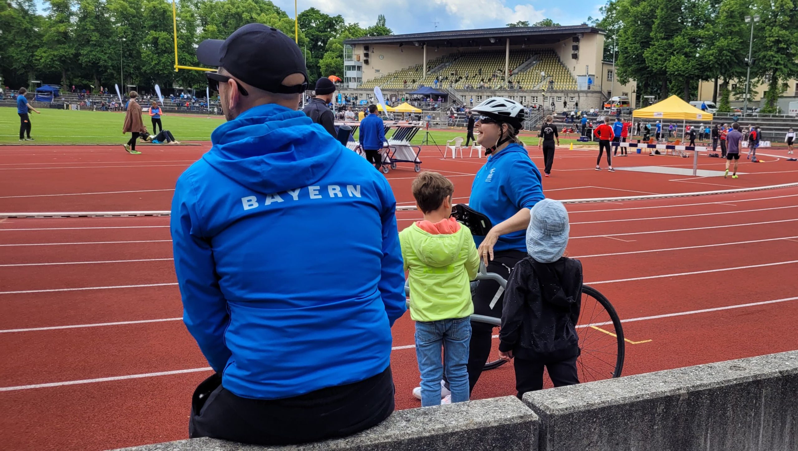 Stefan from the back with his Bavaria Hoddie waiting on the sidelines sitting on a small wall.