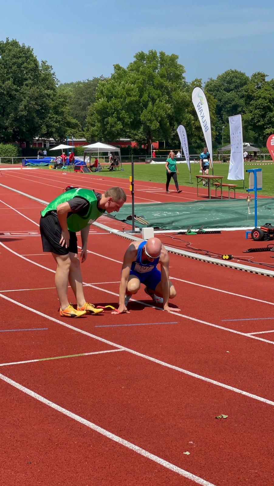 My guide Simon talking to me crouching after the race.