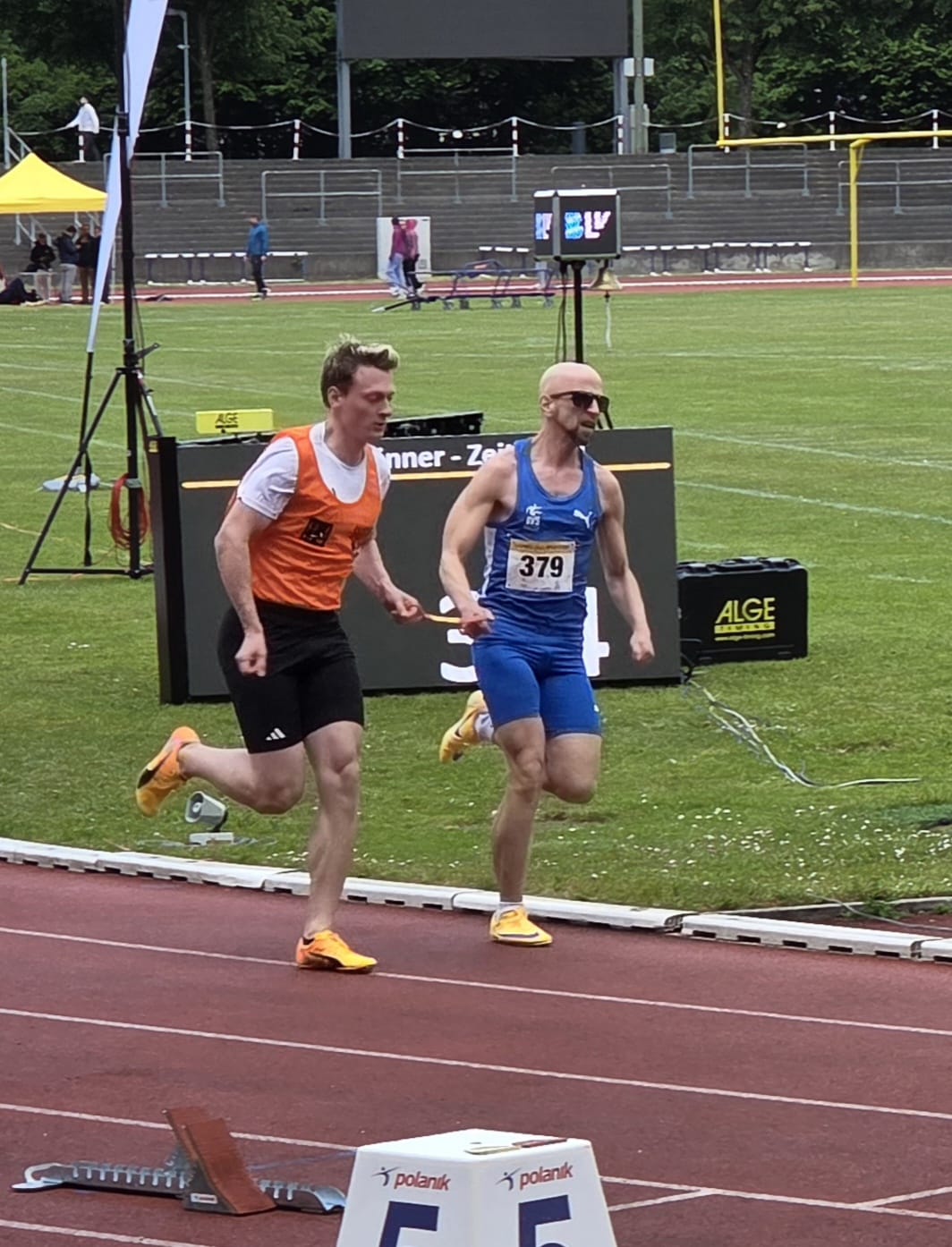 Stefan and Simon on the home straight, ALGE timing board visible behind them.
