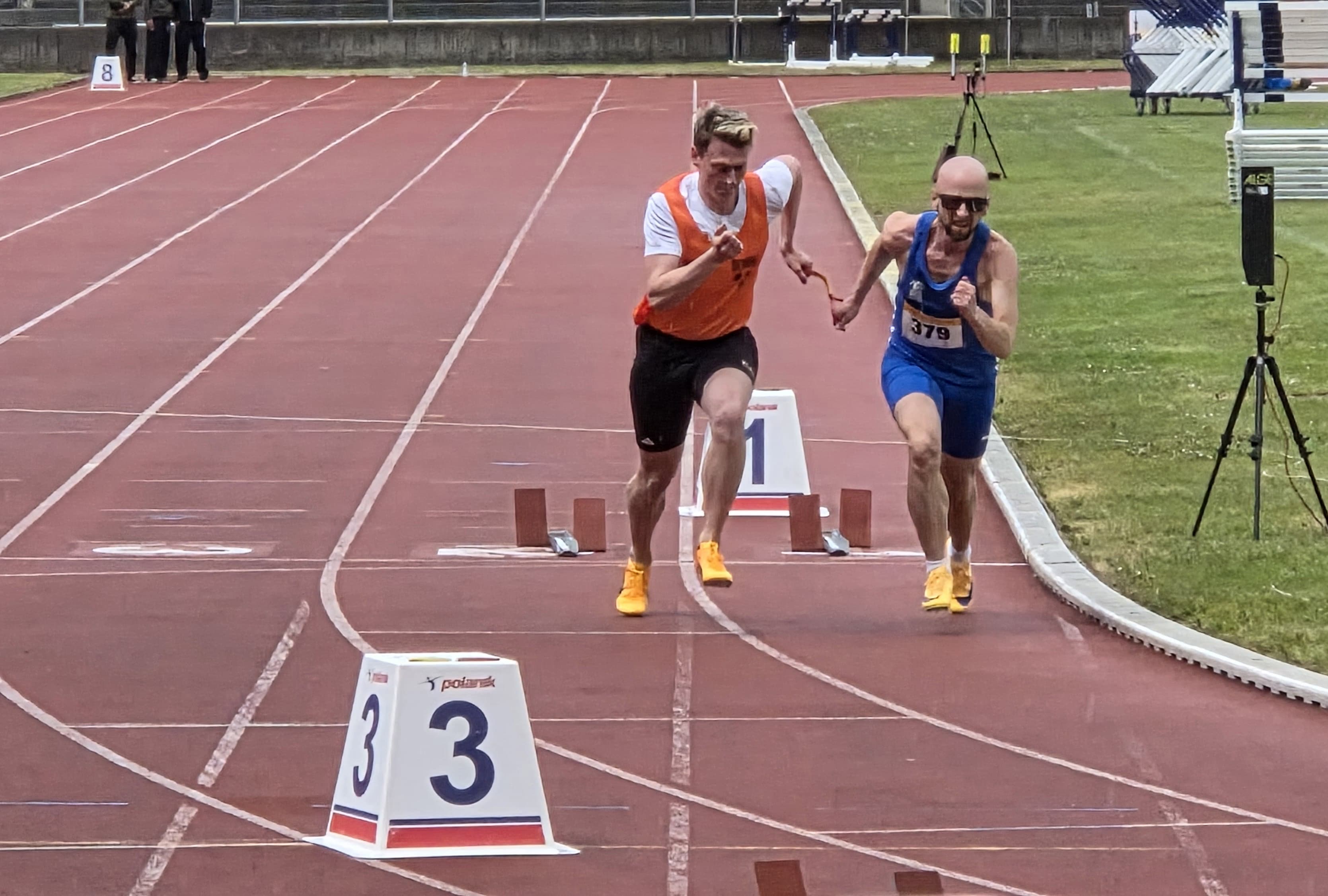 Stefan (bib 379) and guide Simon sprinting out of the blocks on the first straight.